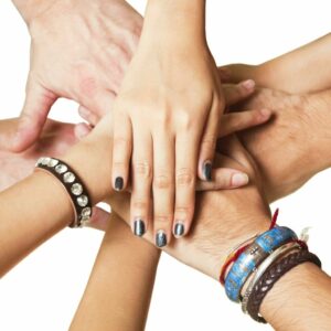 Close-up of human hands clasped together in unity 